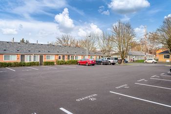 a parking lot with cars in front of a building